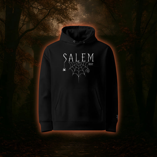Schwarzer Hoodie mit großem Frontprint. Design mit der Aufschrift "Salem 1692", Spinne mit Netz und CCA-Logo. 