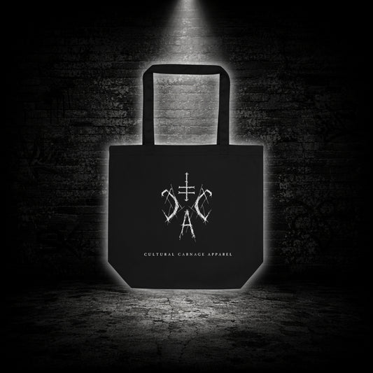 Schwarze Tote Bag mit weißem Sigil-Print und Cultural Carnage Apparel Schriftzug auf der Vorderseite im minimalistischen Alternative-Streetwear-Design.
